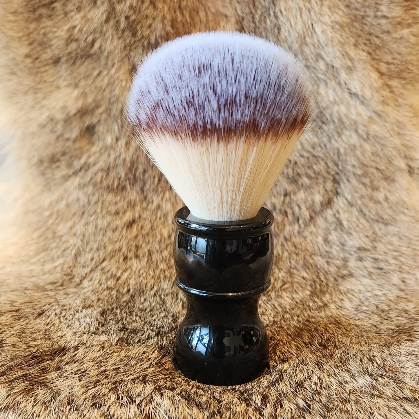 Kent's Good Shaving Kit features a synthetic shaving brush with a glossy black handle and dense bristles, ideal for traditional wet shaving.