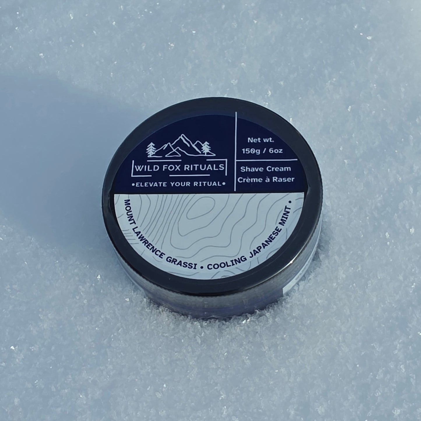 Shave cream container with 'Wild Fox Rituals' branding on a snowy background