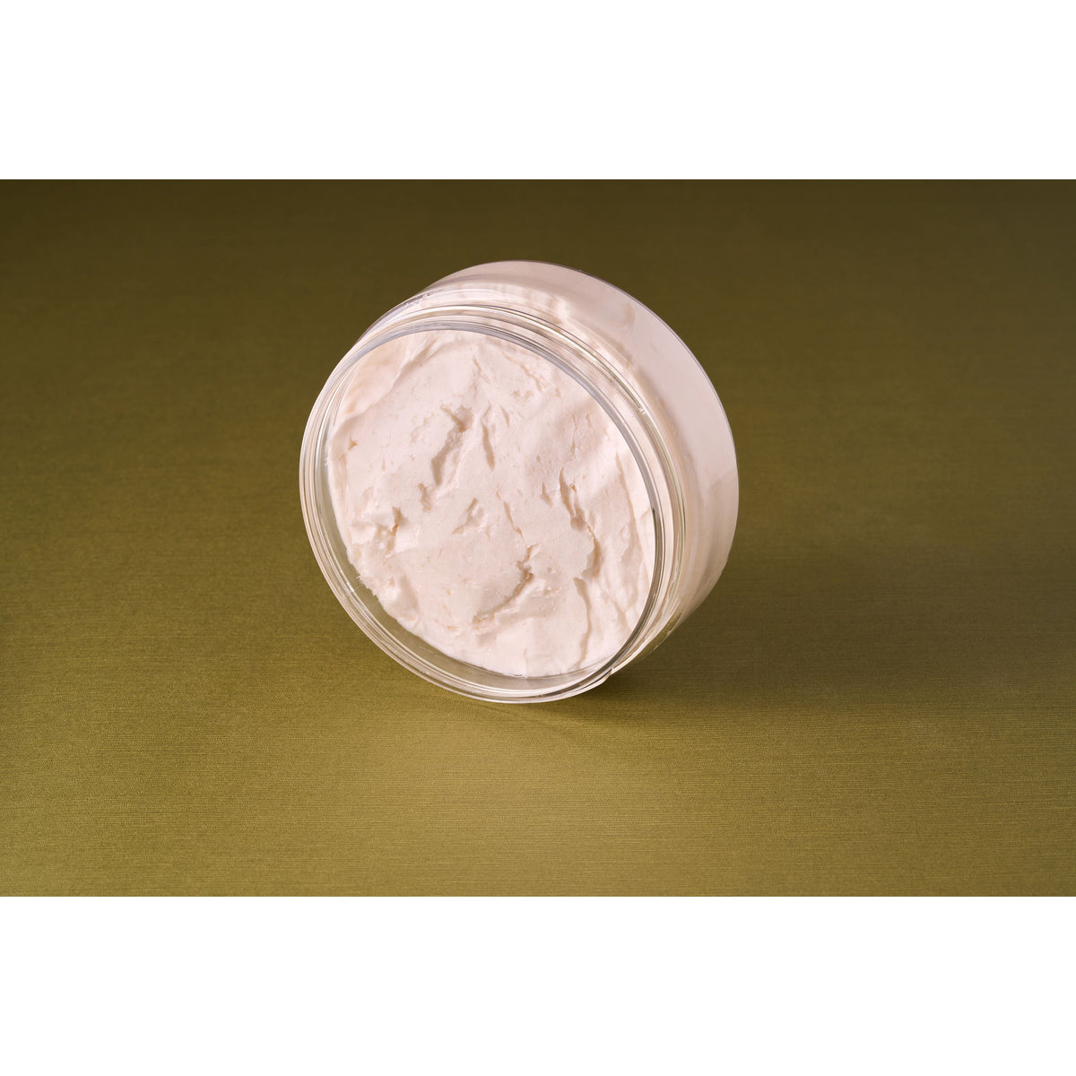 Castle Forbes Lime Essential Oil Shaving Cream 200ml in a clear jar, showcasing its whipped texture, ideal for luxurious and effective shaving.