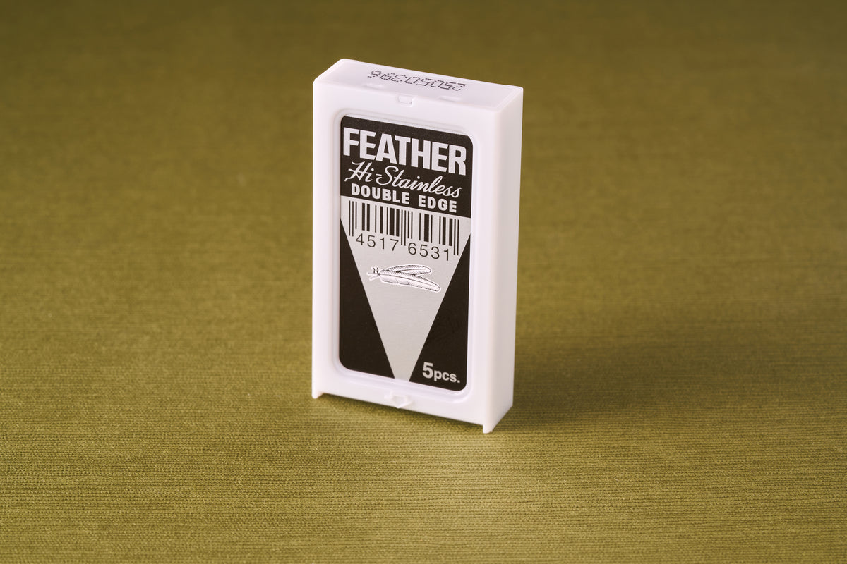 Feather Double Edge Razor Blades, 5 Pack in a white plastic dispenser with logo and barcode, known for exceptional sharpness and smooth shaving experience.