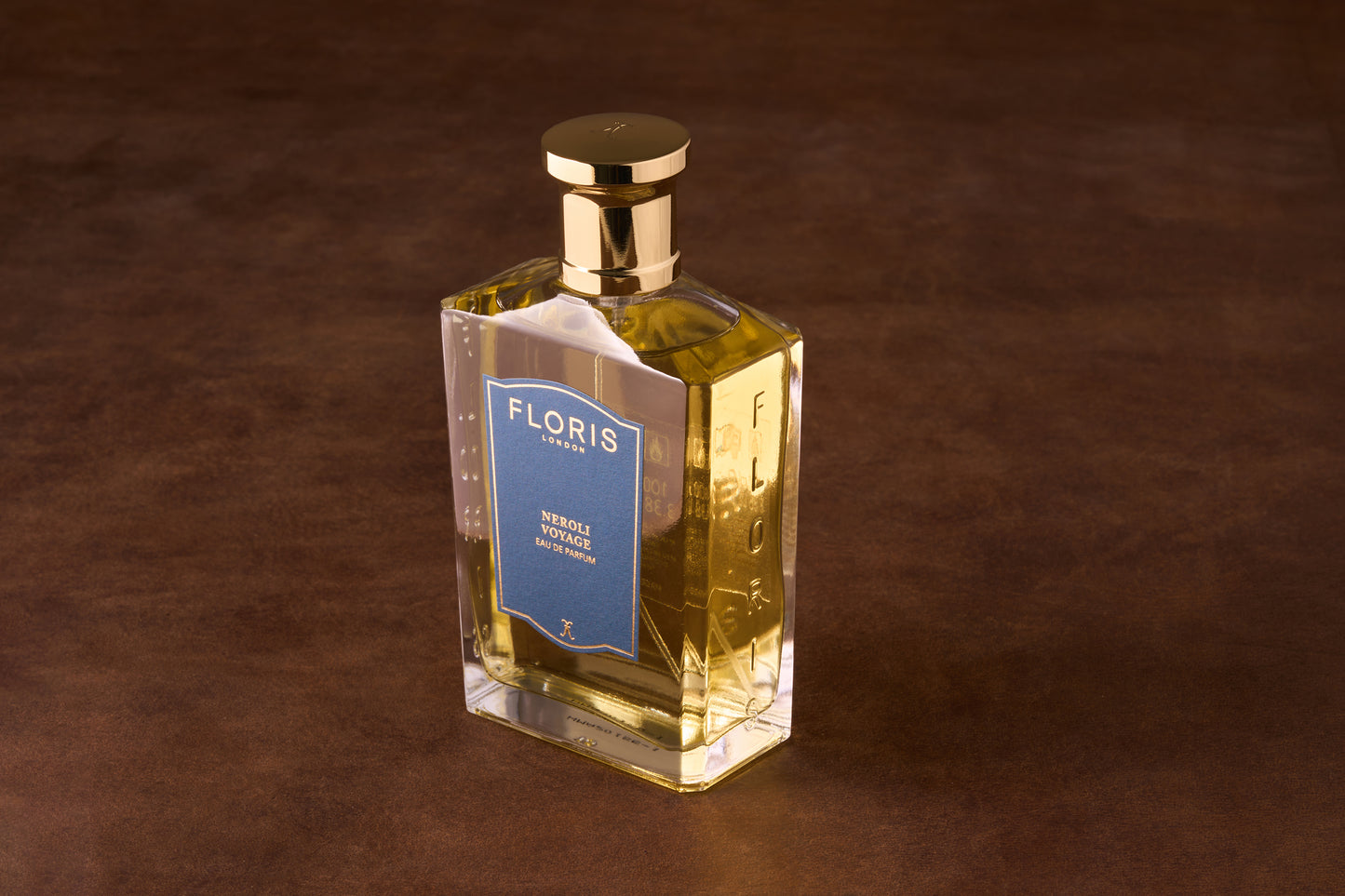 Floris Neroli Voyage Eau de Parfum in a rectangular glass bottle with gold cap, featuring a blue label and embossed brand name.