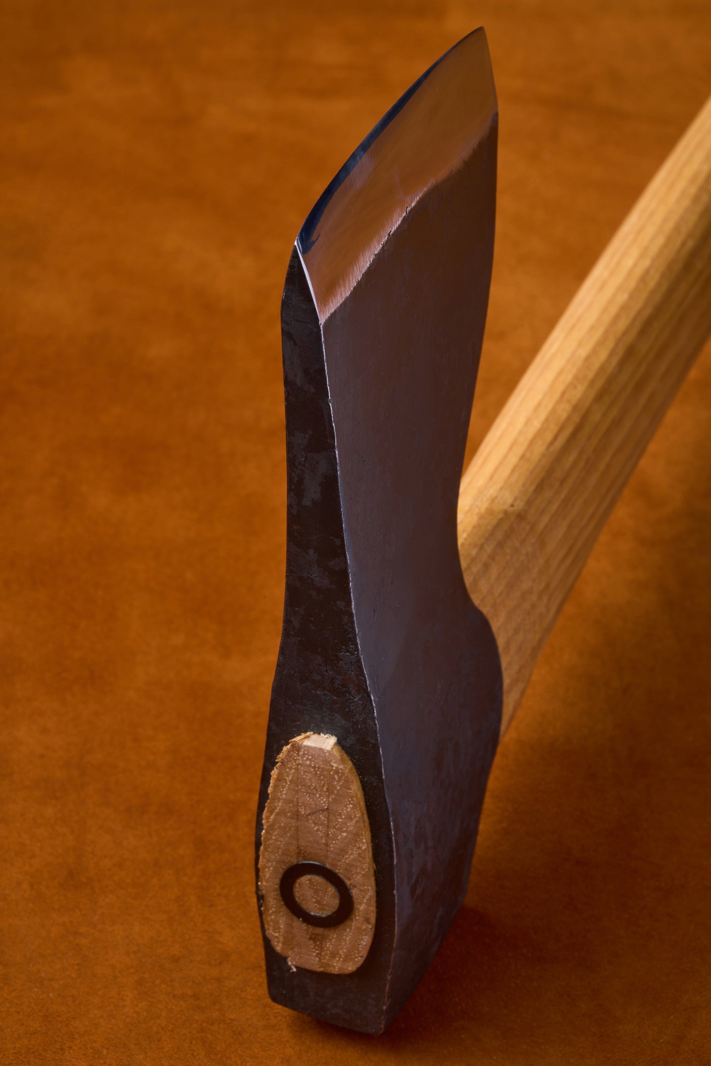 Close-up of a knife with a wooden handle on a brown background