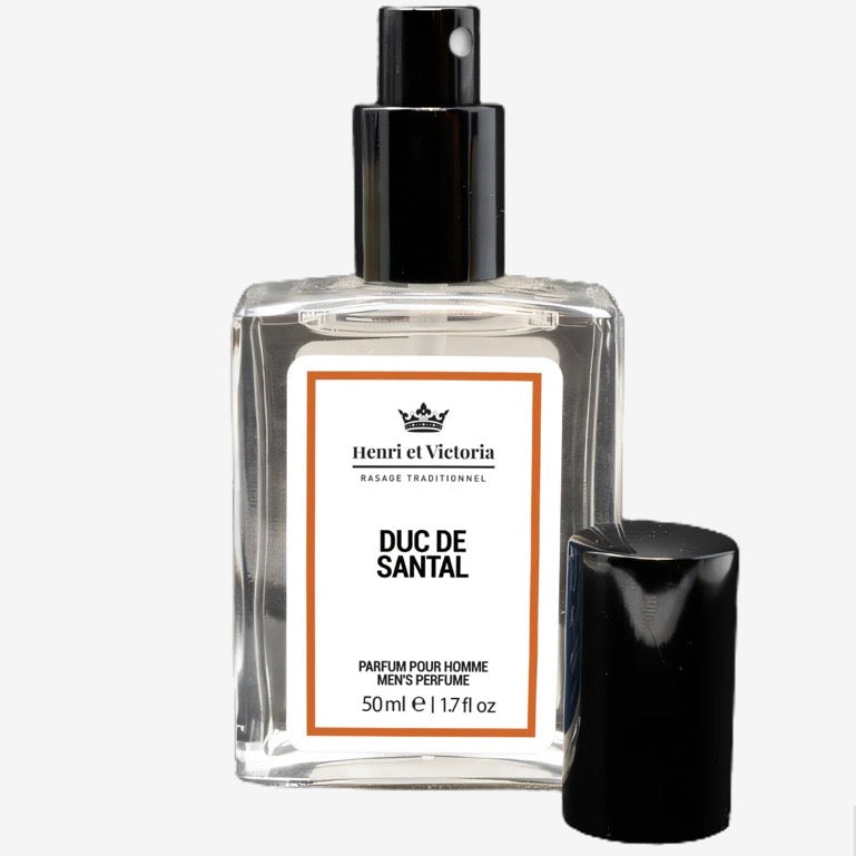 Henri et Victoria Duc de Santal Perfume, a 50 ml glass spray bottle, features a sophisticated musk and sandalwood scent, ideal for travel.