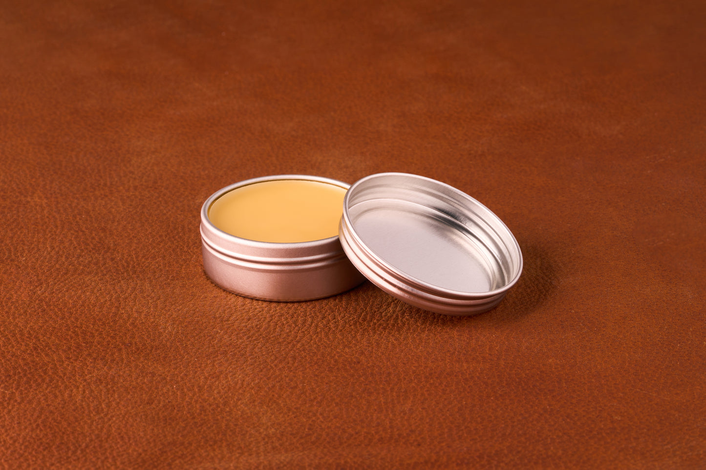 Mammoth Beard Co. Tobacco and Rosewood Moustache Wax 1oz tin with open lid, revealing smooth yellow-tan wax, ideal for styling with a rich, sweet scent.