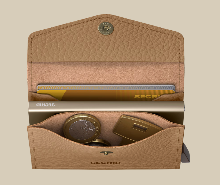 An open Secrid Envelope Wallet in tan leather displays cards, coins, and a gold USB drive neatly inside against a beige background. This wallet offers RFID blocking for secure and stylish organization.