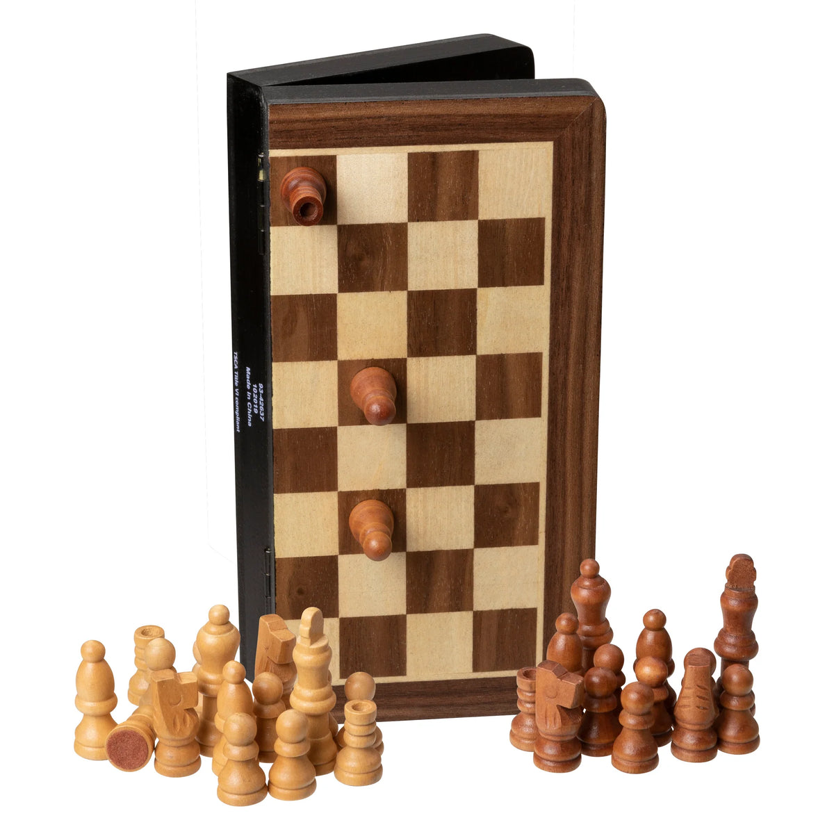 A WE Games Magnetic Folding Travel Chess Set stands open with three pieces attached to its surface, while two sets of light and dark chess pieces are arranged on the table in front.