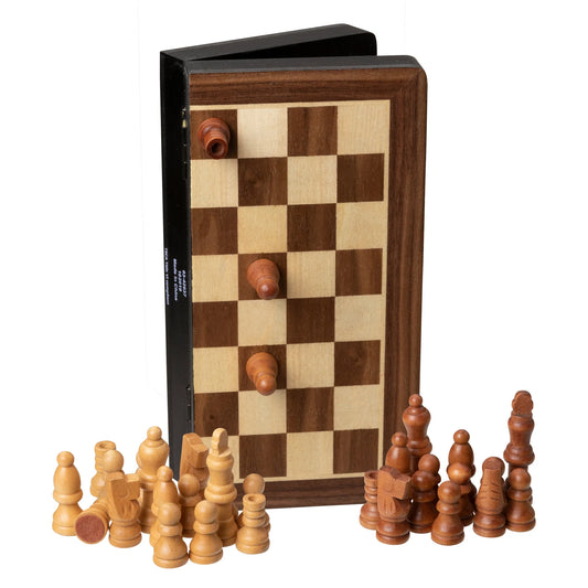 A WE Games Magnetic Folding Travel Chess Set stands open with three pieces attached to its surface, while two sets of light and dark chess pieces are arranged on the table in front.