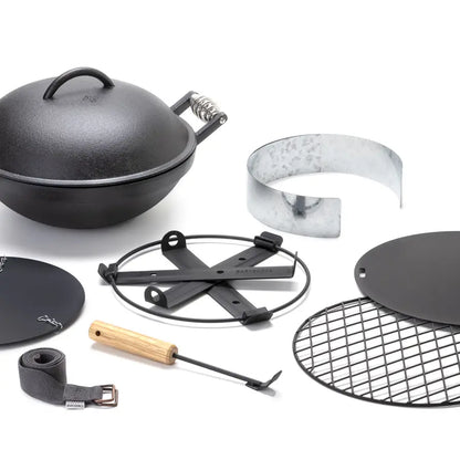Barebones All-in-One Cast Iron Grill: Camp-style kit with Dutch oven, cooking grate, windscreen, trivet, long-handled tool, and strap for open-fire cooking.