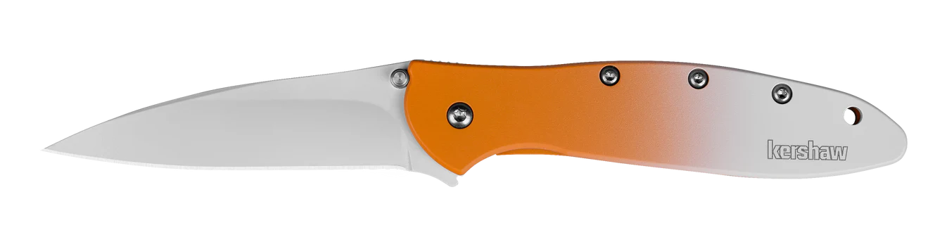 The Kershaw Leek Creamsicle (Limited Edition) is a folding pocket knife with a silver blade, an orange-to-white gradient handle, visible screws, and the Kershaw logo near the handle's end.