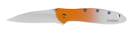 The Kershaw Leek Creamsicle (Limited Edition) is a folding pocket knife with a silver blade, an orange-to-white gradient handle, visible screws, and the Kershaw logo near the handle's end.