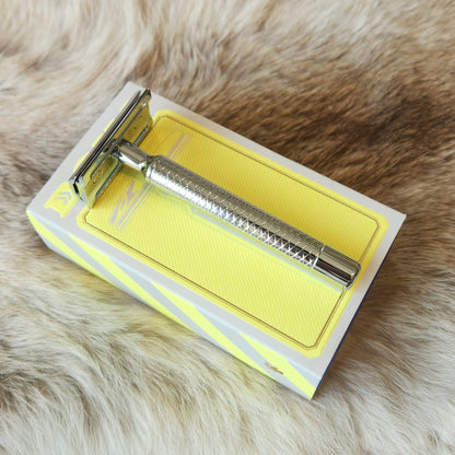 Dovo Primo II Double Edged Safety Razor with a knurled handle and butterfly head on a decorative box, ideal for a refined wet shaving experience.