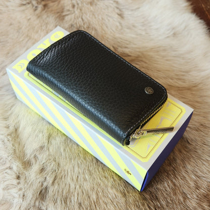 Dovo Manicure Set 4 in black leather, featuring precision grooming tools, displayed with a handmade in Germany zipper on a striped box.