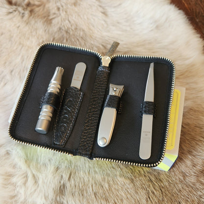 Dovo Manicure Set 4 in a black leather case, showcasing cuticle tools, nail clippers, and a nail file, perfect for precise grooming.
