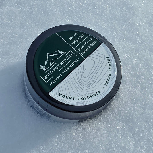 Shave cream container with branding on a snowy background
