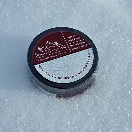 Shave cream container with label on a snowy background