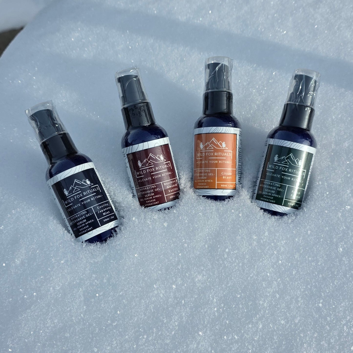 Four bottles of Wild Rose Botanics products on a snowy background