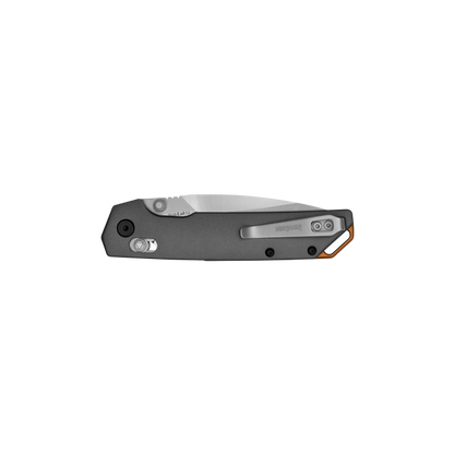 Kershaw Iridium folding pocket knife, closed, with metal handle, pocket-clip, flipper tab, and liner-lock mechanism, showcasing sleek functionality and craftsmanship.