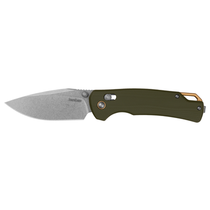 The Kershaw Proximal is a folding pocket knife featuring a durable D2 blade with a stonewashed finish, an olive green textured G10 handle for enhanced grip, a thumb stud for easy opening, and a gold-colored carabiner clip at the end of the handle—making it an ideal everyday carry folder.
