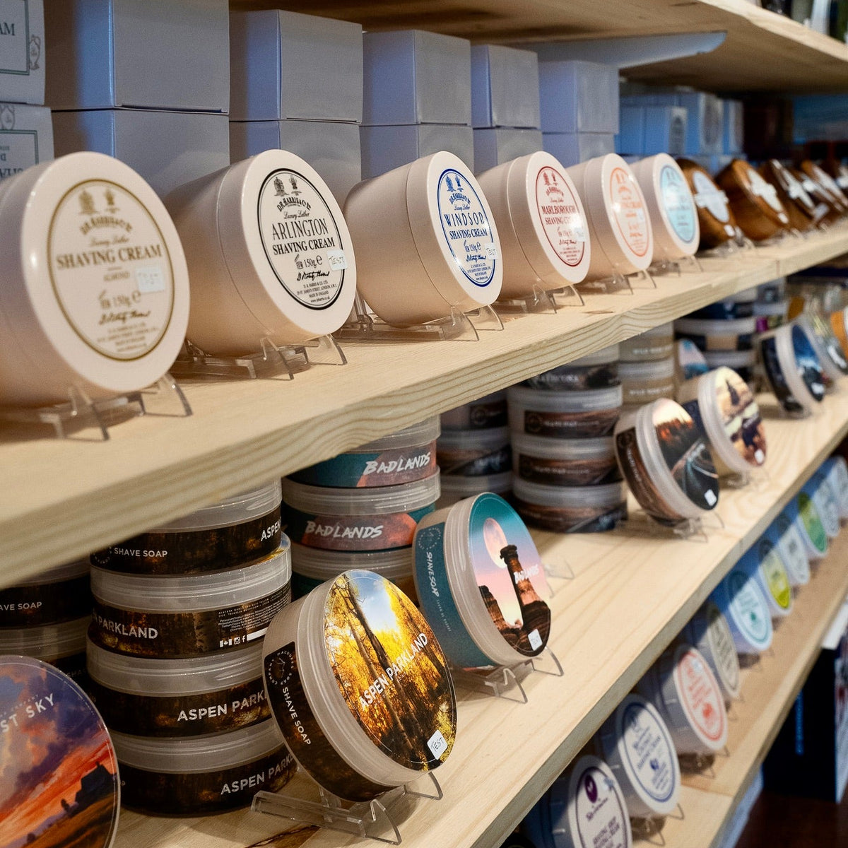 Shelves with various cosmetic products including jars and boxes in a store setting.