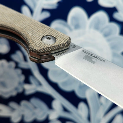 Kershaw Federalist folding pocket knife with textured micarta handle and CPM154 steel blade, stamped 4320 USA and American flag icon, showcasing quality craftsmanship.