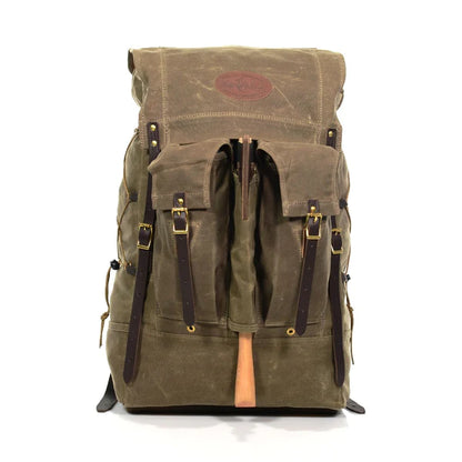 Frost River Isle Royale Pack, a vintage-style rucksack with waxed canvas, leather straps, and brass hardware, designed for durability and comfort on rugged adventures.