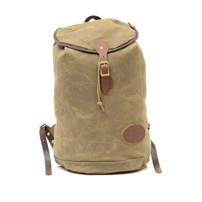 Frost River Summit Pack, a waxed-canvas rucksack with leather accents and brass hardware, ideal for minimalist travel, reflecting rugged, reliable craftsmanship.