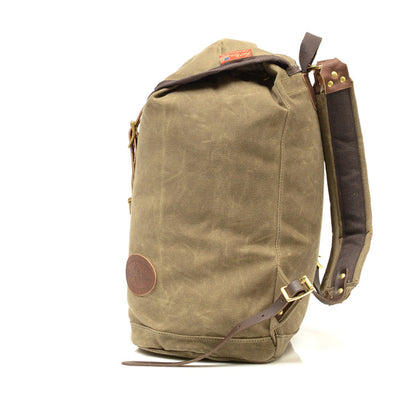 Frost River Summit Pack: Roll-top waxed canvas backpack with leather trim, brass hardware, and padded straps, ideal for minimalist travel.