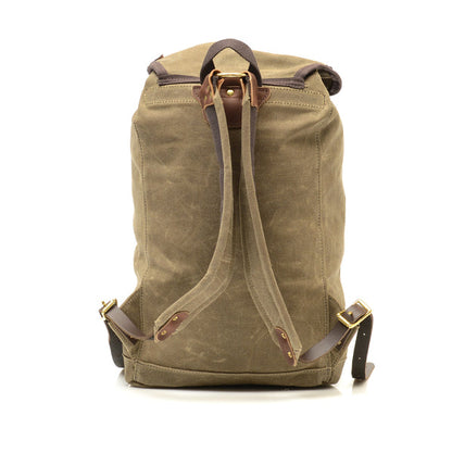 Frost River Summit Pack in waxed canvas, featuring leather-trimmed adjustable straps and brass hardware, embodies rugged simplicity and ultimate travel utility.