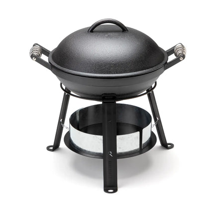 Barebones All-in-One Cast Iron Grill, a portable charcoal grill with dome lid, three-legged stand, adjustable tray, and griddle, ideal for versatile outdoor cooking.