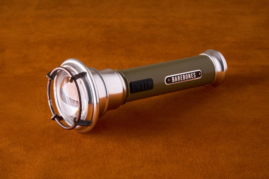 Flashlight with 'Barebones' branding on a brown background