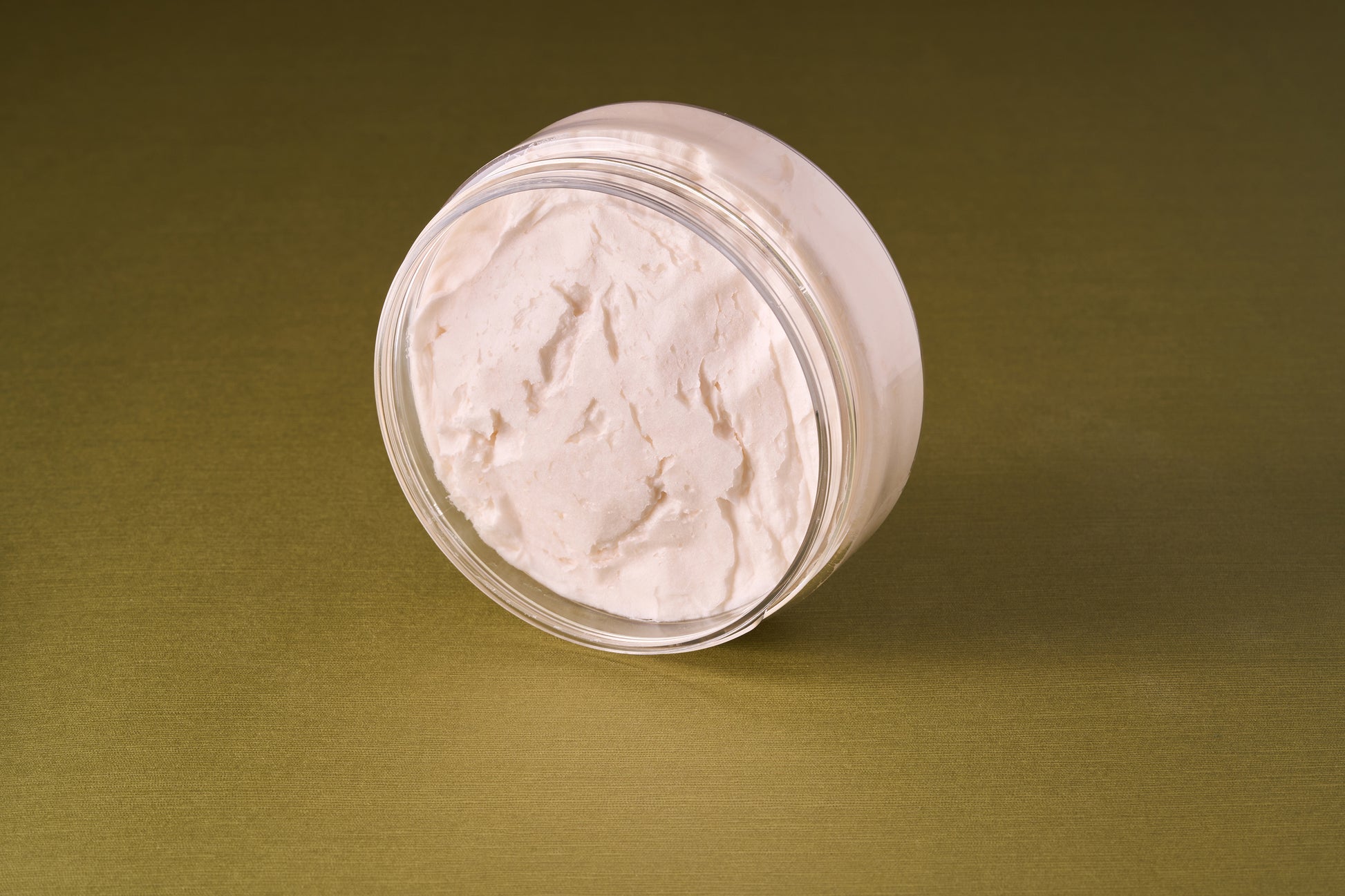 Castle Forbes Lime Essential Oil Shaving Cream 200ml in a clear jar, showcasing its whipped texture, ideal for luxurious and effective shaving.