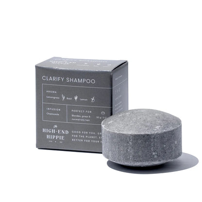 The High End Hippie Clarify Shampoo Bar beside its branded box, ideal for blondes and oily hair, with lemongrass, basil, and lemon fragrance, chamomile infusion.