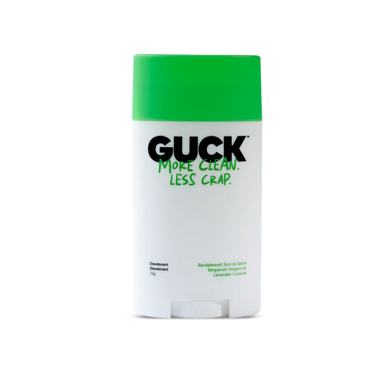Deodorant stick with green cap and white body on a white background