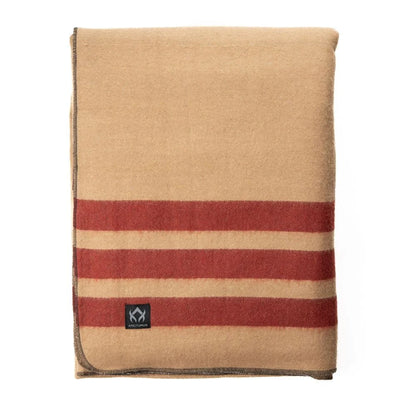 Arcturus Rainier Wool Blanket, tan with rust-red stripes, folded showing a black Arcturus label; durable, ideal for outdoor use, crafted from 70% wool.