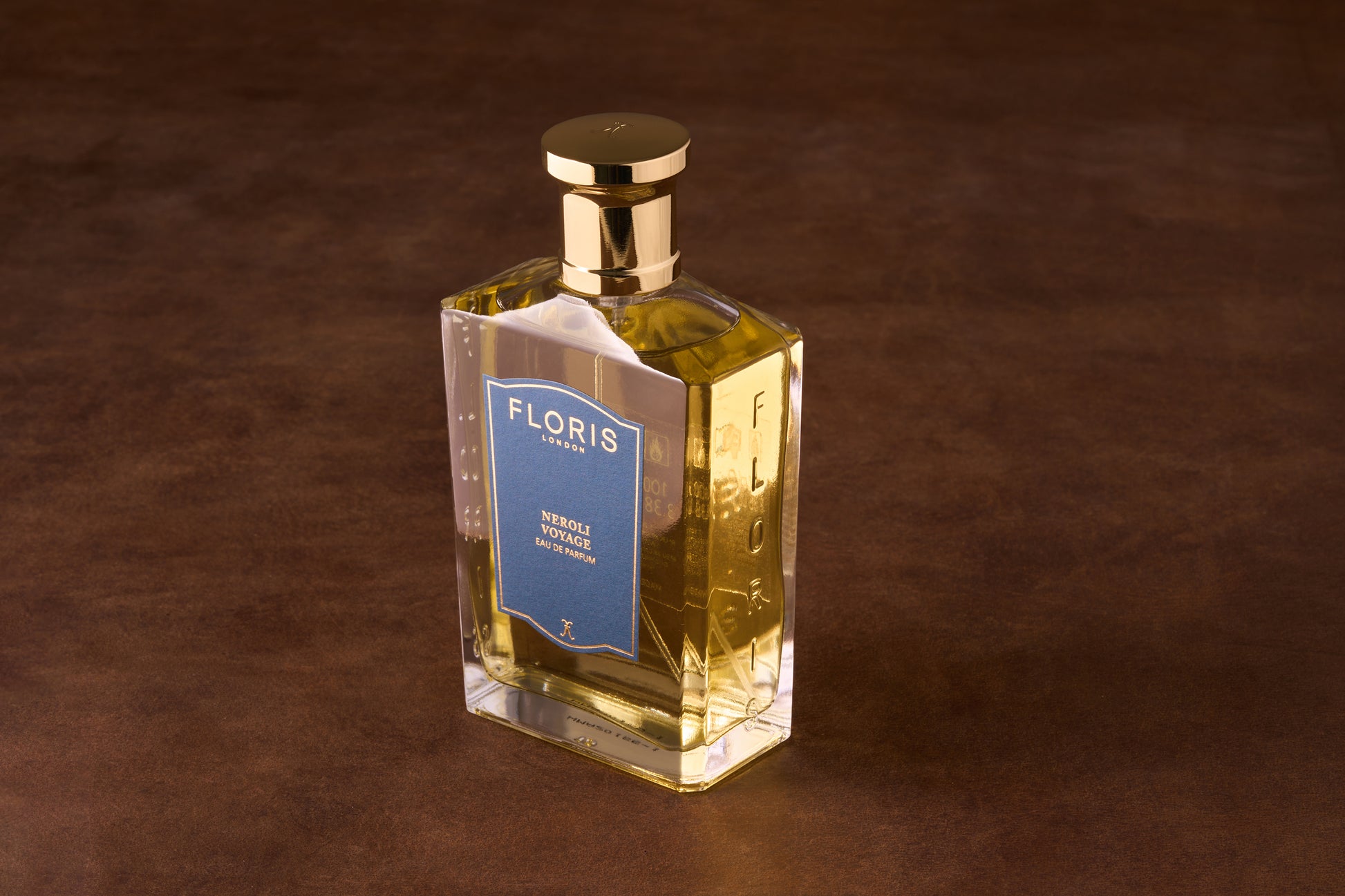 Floris Neroli Voyage Eau de Parfum in a rectangular glass bottle with gold cap, featuring a blue label and embossed brand name.