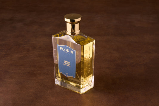 Floris Neroli Voyage Eau de Parfum in a rectangular glass bottle with gold cap, featuring a blue label and embossed brand name.