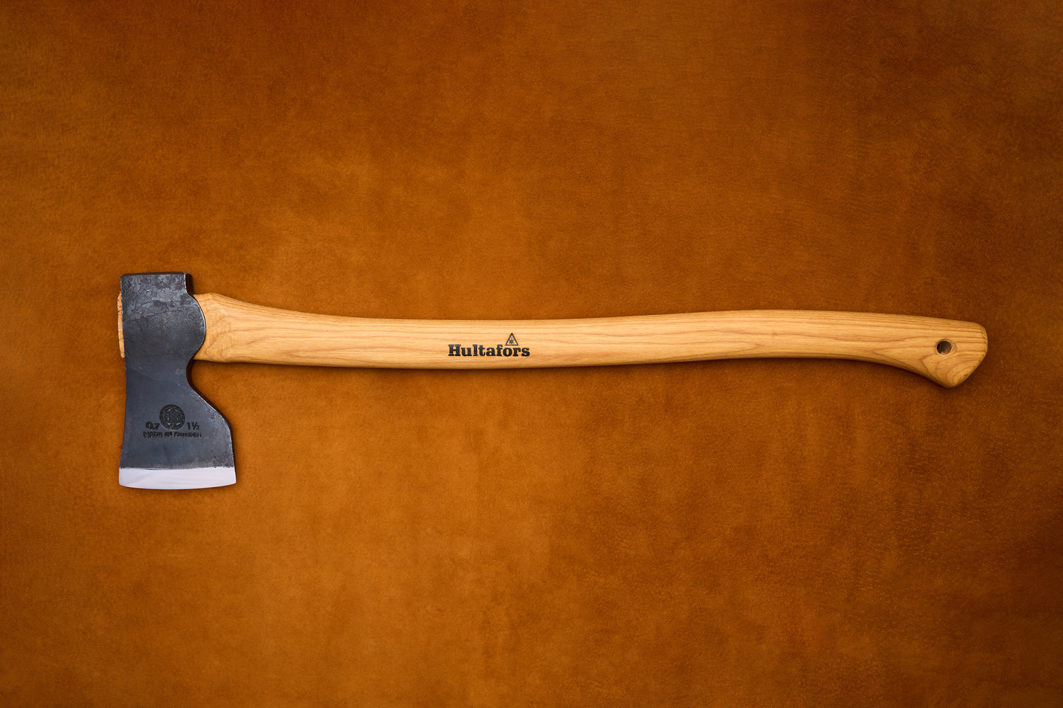 Axes with wooden handles on a brown leather background