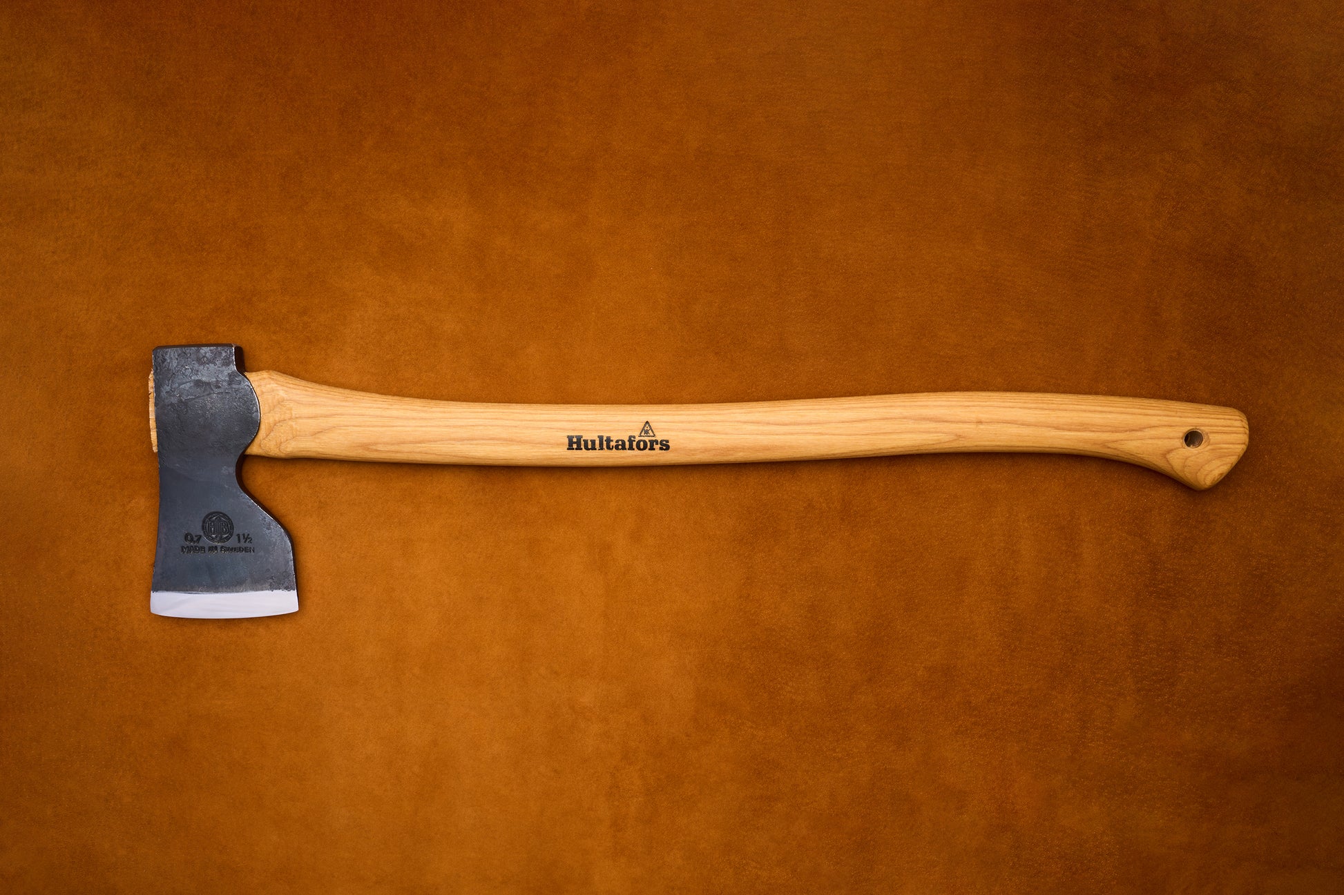 Axes with wooden handles on a brown leather background