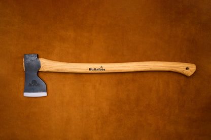 Axes with wooden handles on a brown leather background