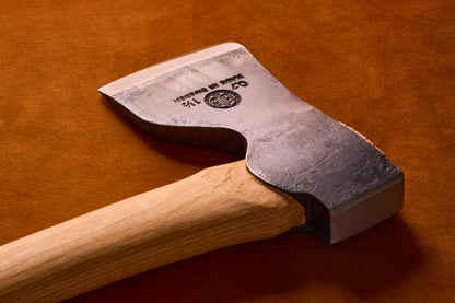Wooden-handled axe with a metallic head on a brown background