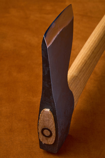 Close-up of a knife with a wooden handle on a brown background