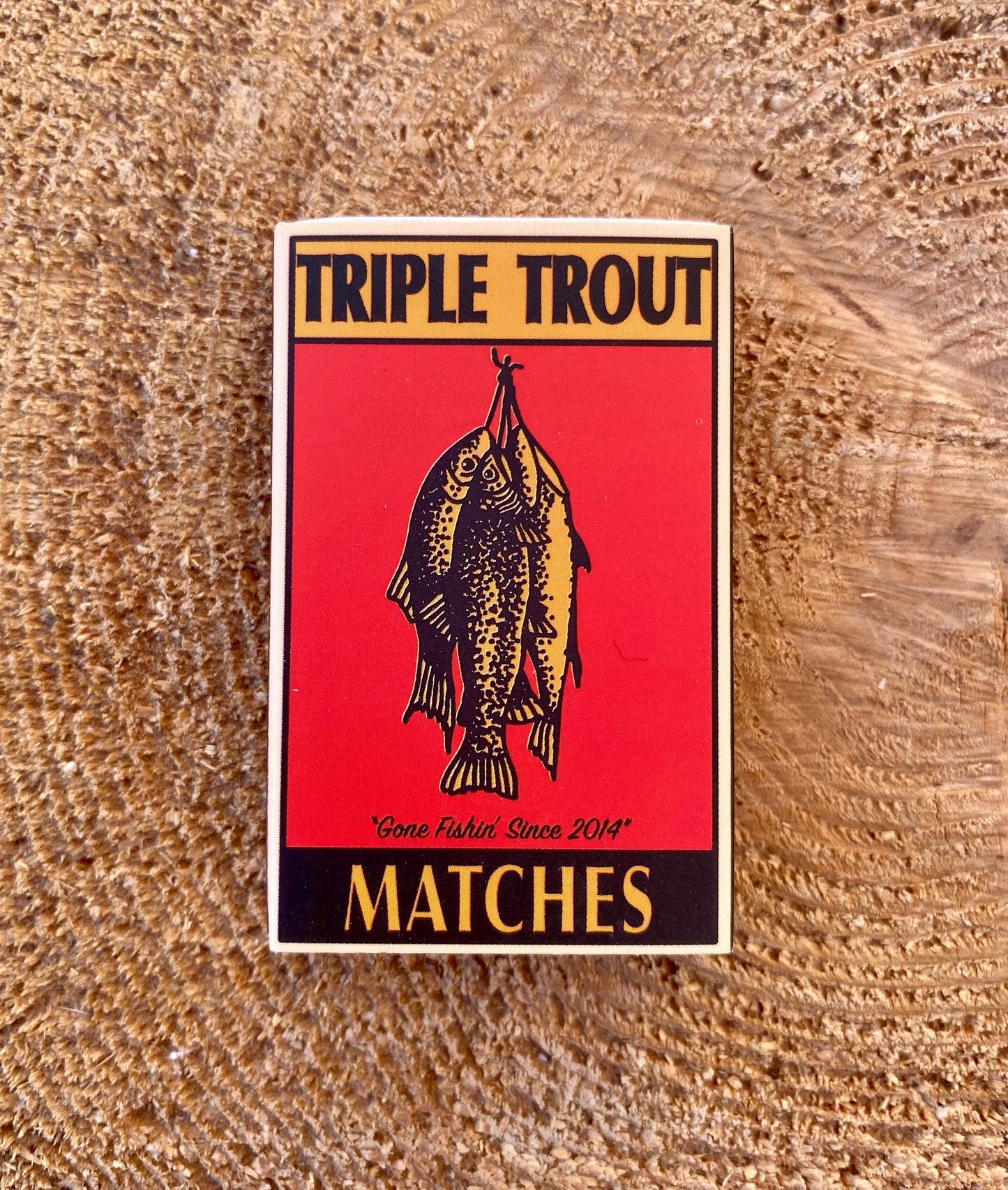 Triple Trout matches packaging on a wooden surface