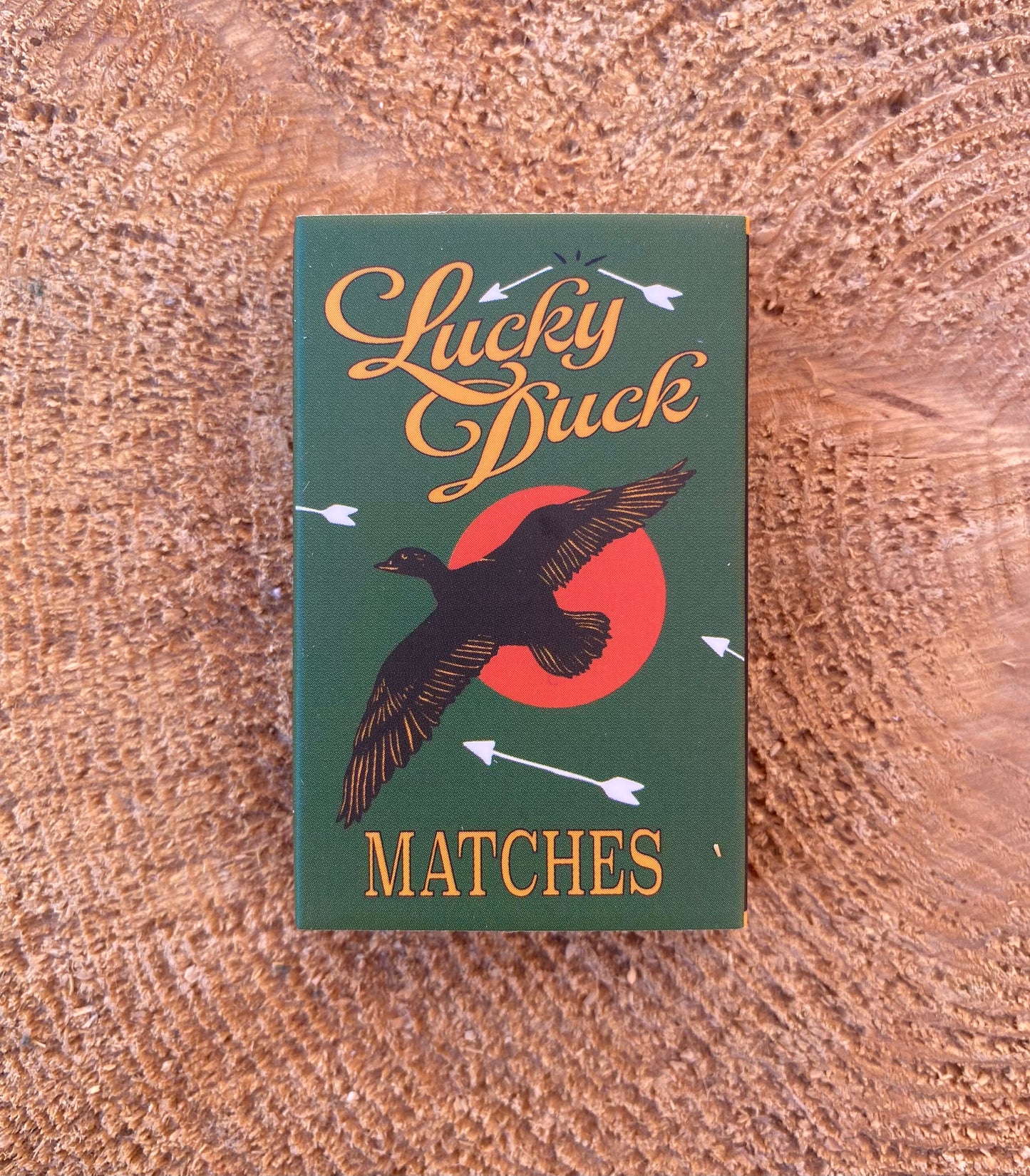 Matches box with 'Lucky Duck' branding on a wooden surface