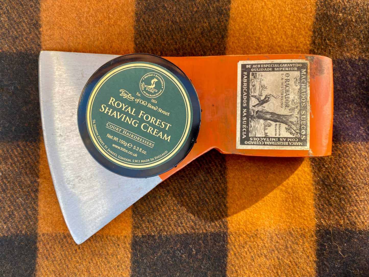 Taylor of Old Bond Street Royal Forest Shaving Cream, 5.3 oz, placed on a vintage-labeled Swedish axe head, highlighting classic shaving with fresh, woody fragrance.
