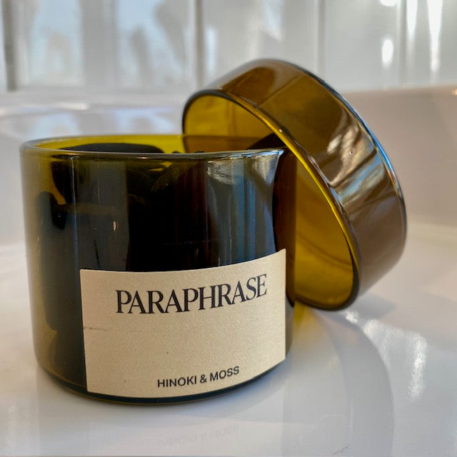 Paraphrase Incense Cones in an amber-glass jar, labeled Hinoki & Moss, exemplifies handcrafted fragrance, enhancing personal exploration and ambiance.