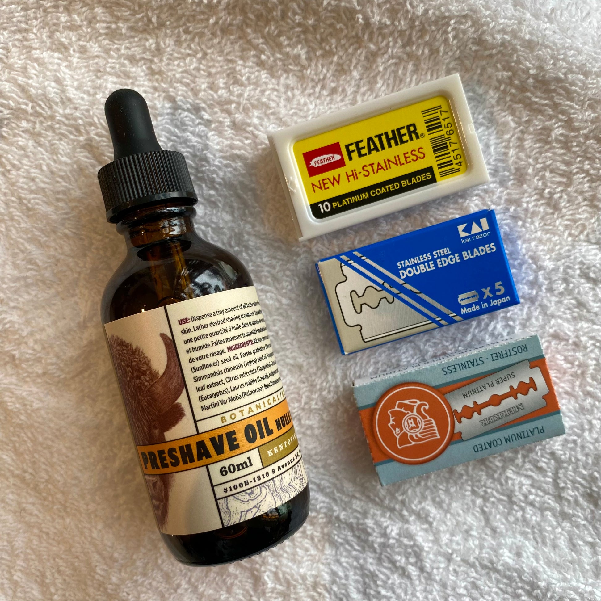 Coarse Hair Shaving Kit featuring an amber dropper bottle of pre-shave oil and three packs of aggressive double-edge razor blades for a smooth, irritation-free shave.