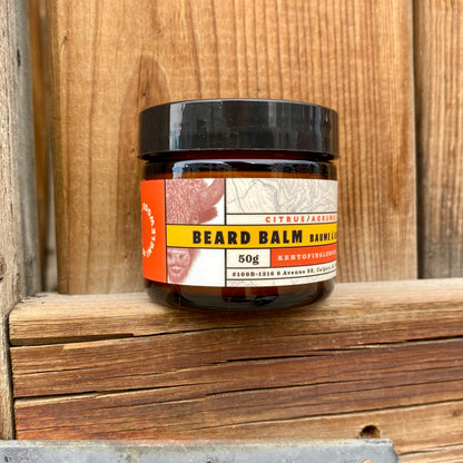 Kent of Inglewood Citrus Beard Balm in an amber jar, offers light hold and moisture with a refreshing citrus scent, ideal for grooming and beard care.