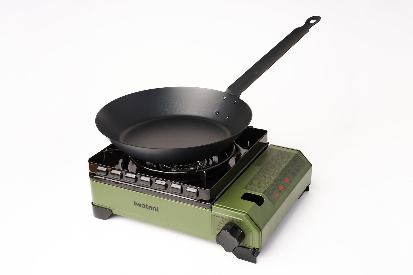 A black frying pan sits on an Iwatani Cassette Konro "Tough Maru" Portable Stove with control knobs and the brand name “Iwatani” visible on the base, set against a plain white background.