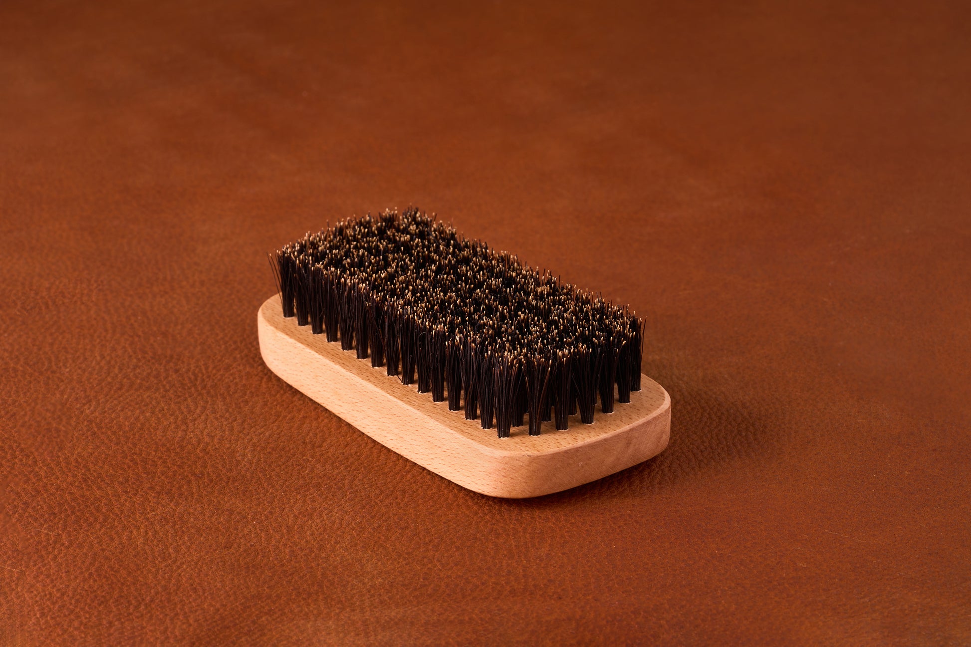 Kent Of Inglewood Boar Bristle Beard Brush with wooden handle, featuring densely packed natural bristles for grooming and enhancing beard softness and shine.