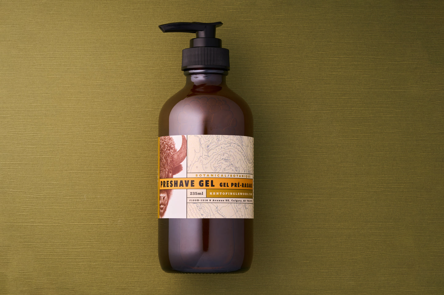 Kent of Inglewood Botanical Preshave Gel 250ml in a brown-amber pump bottle on textured surface, designed to soften beards and enhance shaving comfort.